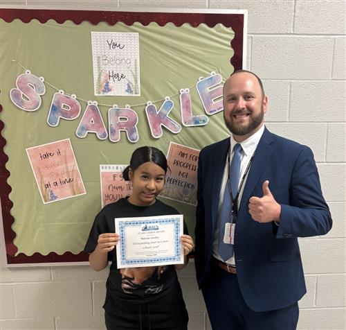 Malisha Ghalley, East Middle School's Stairclimber for October, poses with his award plaque.